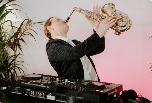 Saxophonist playing live over a DJ set